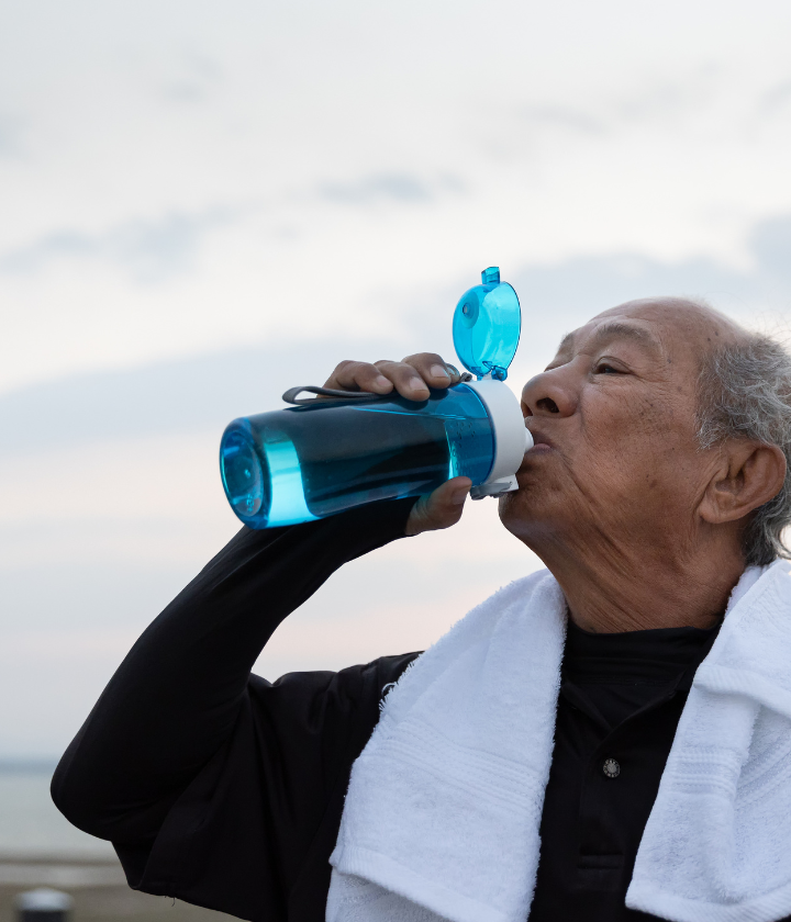 Older man drinking water after exercise